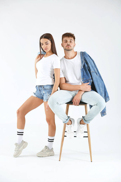 Fashionable young couple on white background - Фото, изображение