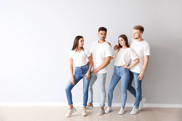 Group of young people in stylish casual clothes near light wall - Photo, Image