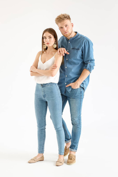 Fashionable young couple in stylish casual clothes on white background - Fotografie, Obrázek