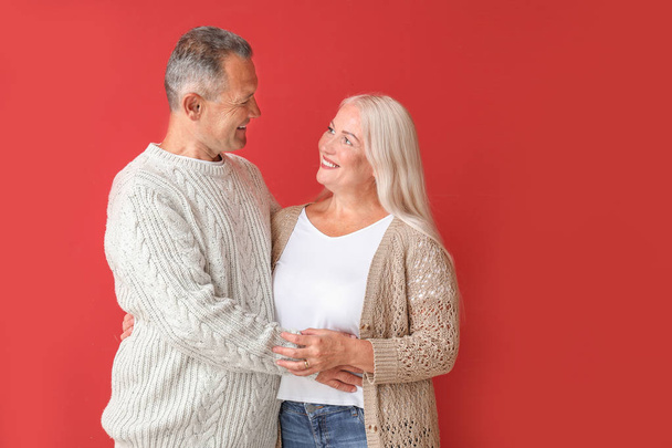 Portrait of happy mature couple on color background - Photo, Image