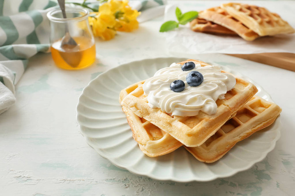 Plate with tasty waffles on white table - Photo, Image