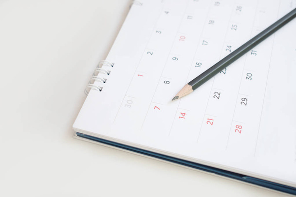 A pencil on the calendar With selectable focus for remark or mem - Photo, Image