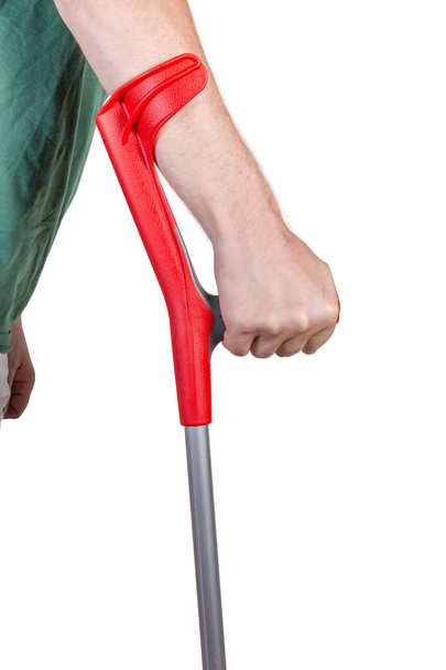 Parte superior da muleta de cotovelo na mão masculina
 - Foto, Imagem
