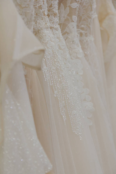 Beautiful wedding dresses in a bridal salon. - Photo, Image