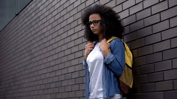 Lonely afro-american schoolgirl standing college backyard, puberty insecurities - Fotoğraf, Görsel