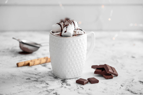 Cup of hot chocolate with marshmallows on white table - Fotografie, Obrázek