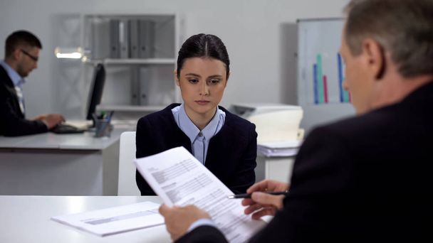 Angry boss shouting on sorrowful female manager made mistake in documents - Foto, imagen