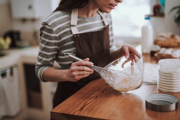 Young housewife is kneading dough at home - Photo, Image