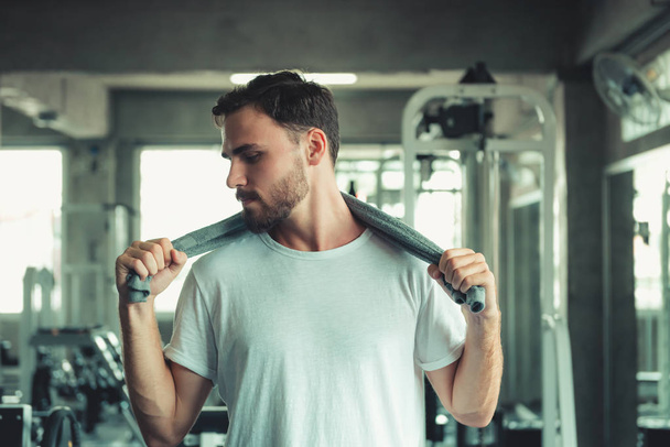 Handsome Healthy Man Holding Sweating Towel Exercised in Fitness Sport Club. Portrait of Strong Man Doing Exercising in Gym. Sport Leisure Activities and Fitness Lifestyle Concept - Photo, Image