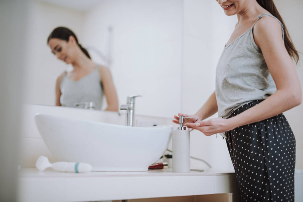 Pleasant nice woman using soap in the bathroom - Foto, imagen