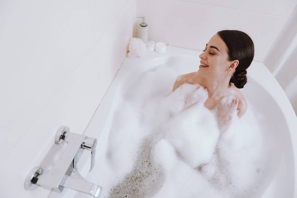 Top view of a nice overjoyed woman taking bath - Foto, Imagem