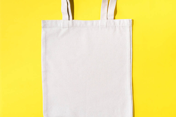 Reusable textile bag on yellow background. Zero waste concept with copy space. Zero waste, plastic free concept. Top view. Eco friendly mesh shopper. - Foto, imagen