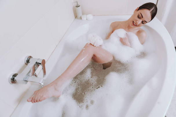 Top view of a positive nice woman washing her body - Φωτογραφία, εικόνα