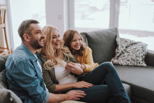 Happy family resting on comfortable couch at home - Photo, image