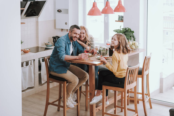 Happy family spending time together and enjoying dinner at home - Photo, image