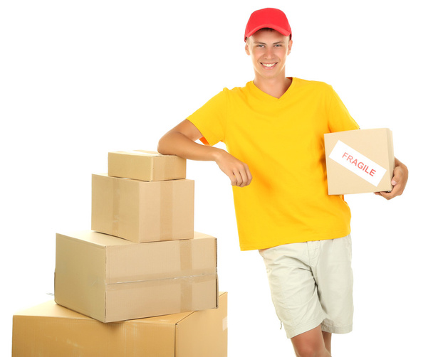 Young delivery man with parcels, isolated on white - Фото, зображення