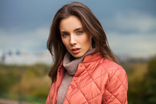 ,,Portrait of a young beautiful woman in a pink jacket - Фото, изображение