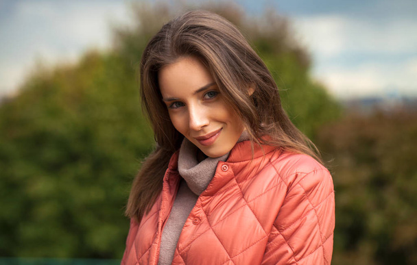 ,,Portrait of a young beautiful woman in a pink jacket - Foto, afbeelding