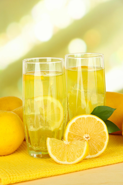 Delicious lemonade on table on light background - Foto, afbeelding