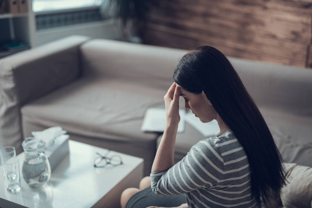 High angle of depressed woman holding her head in hands indoors - Photo, image