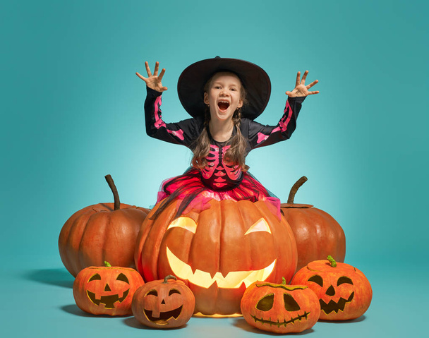 little witch on turquoise background - Foto, imagen
