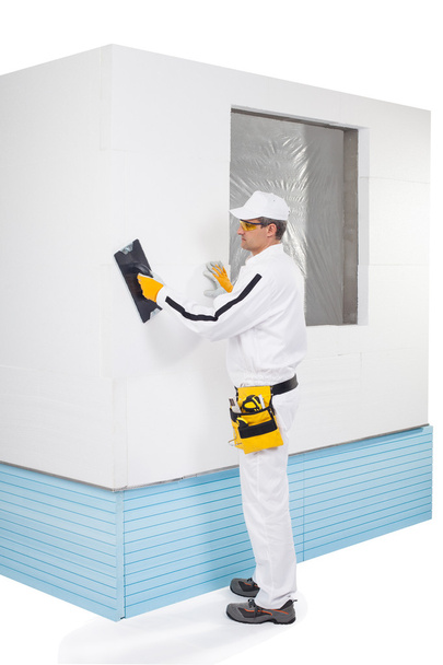 Worker rasping insulation panels - Photo, Image