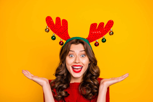 Pretty lady overjoyed with xmas decor wear head horns and knitted pullover isolated yellow background - Foto, imagen