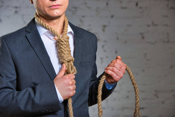 Mature businessman with noose at office - Foto, Imagen