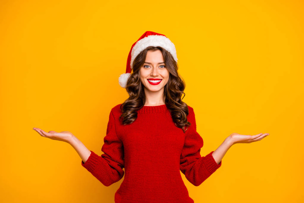 Beautiful lady hold sale novelty on open arms wear red knitted sweater and santa hat isolated yellow background - Photo, Image