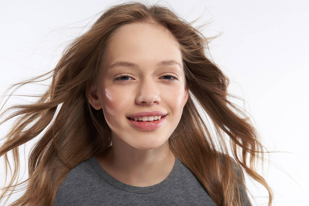 Beautiful teen girl with flying hair expressing positive emotions - Fotoğraf, Görsel