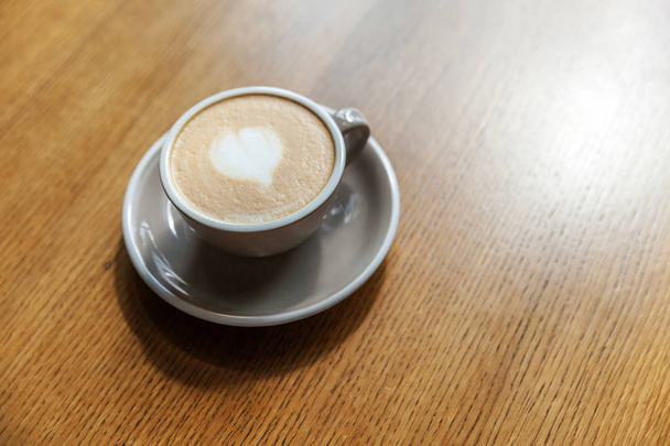 Coffee cup fresh cream organic cappuccino on table in cafe - Фото, изображение