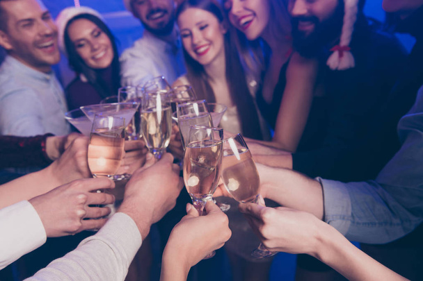 Cropped close-up view of nice attractive cheerful cheery positive girls and guys having fun rest relax clinking wineglass congrats winter December in luxury place nightclub indoors - Foto, Imagem