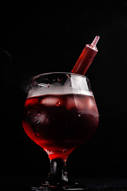 Bloody alcoholic cocktail with a syringe. - Valokuva, kuva
