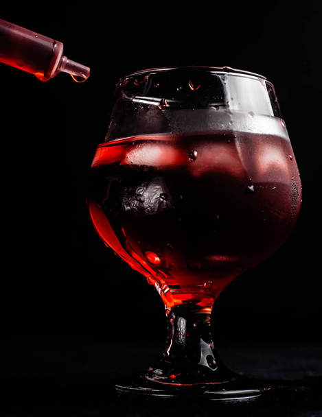 Bloody alcoholic cocktail with a syringe. - Valokuva, kuva