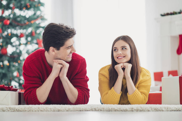 Close up photo of two spouses people with brown red hair lying on floor enjoy newyear holidays christmas time wear yellow pullovers in house indoors - Foto, Bild