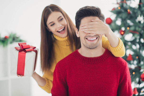 Close up photo of two romantic married people woman close face eyes her boyfriend hold gift box prepared for christmas midnight follow x-mas tradition in house with new year decoration - Foto, immagini