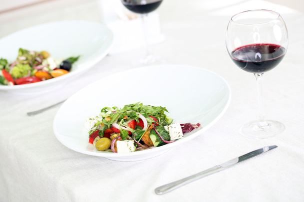 Greek salad on white plate, close up - Photo, image