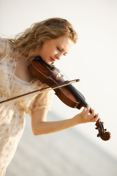 Portrait blonde girl with a violin outdoor - Фото, зображення