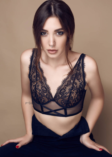 Beautiful sexy brunette woman with juicy lips in dark underwear - Фото, зображення