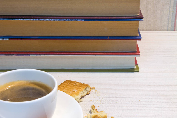 Espresso Cup with cookies and books on the white table - Fotó, kép