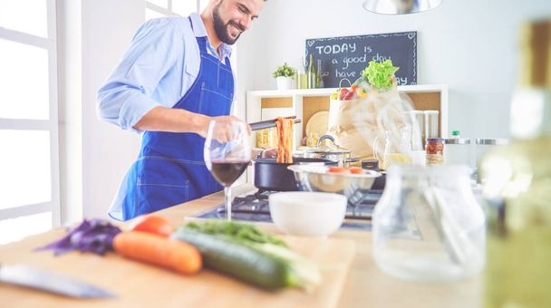 Man preparing delicious and healthy food in the home kitchen - Photo, Image