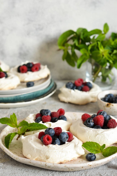 Classic dessert pavlova with cream and berries and almonds  - Fotografie, Obrázek