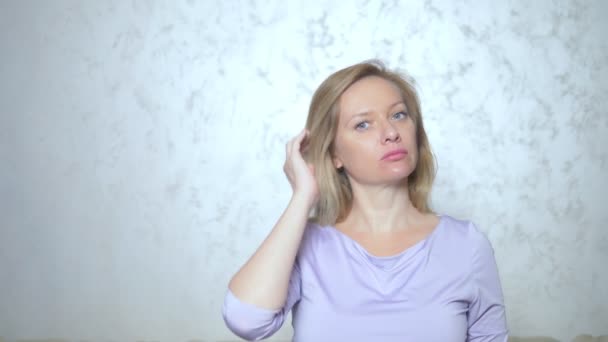 hair loss problems, alopecia. the woman has shreds of hair during combing. lost hair remains in her hands - Video