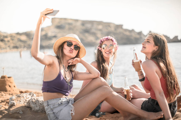 Girls takes a selfie on the beach - Photo, Image