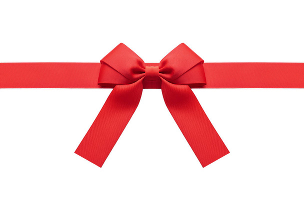 A red ribbon with a bow on a white. - Zdjęcie, obraz