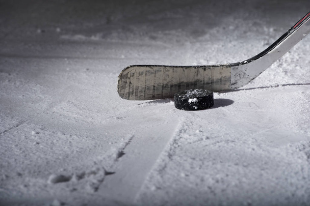 Hockey Stick and Puck on the Ice Rink - Photo, Image