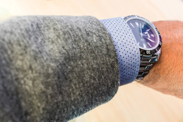 man's arm showing steel watch with shirt and jacket - Photo, Image
