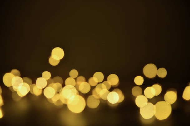 Abstract bokeh background of defocused lights. Merry Christmas and New Year background. Holiday glowing background and wallpaper. Blurred Bokeh. - Photo, Image
