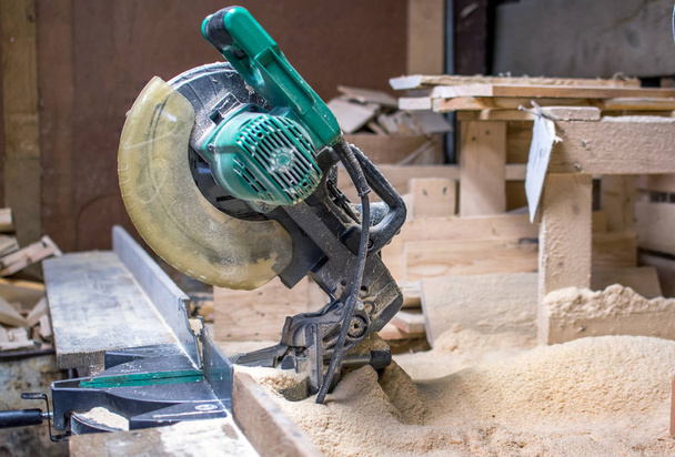 chop saw in a wood workers shop - Fotó, kép