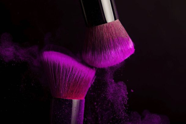Βούρτσα καλλυντικών και πολύχρωμη σκόνη μακιγιάζ - Φωτογραφία, εικόνα